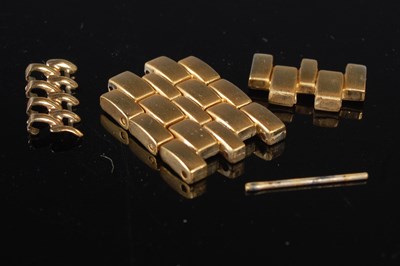 Lot 90 - Three yellow metal coloured watch links.