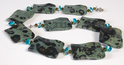 Lot 124 - A green polished stone rectangular panelled...