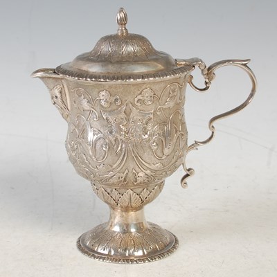 Lot 133 - A 19th century white metal lidded jug, makers...