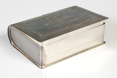 Lot 172 - A white metal box in the form of a book, with...