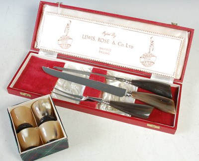 Lot 401 - A cased three piece horn handled carving set;...