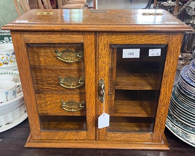 Lot 469 - A late 19th century oak table top smokers...