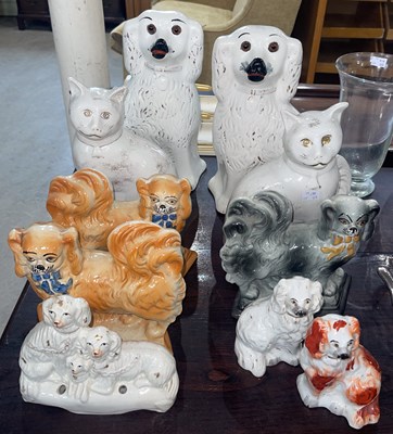 Lot 475 - A collection of assorted pottery dogs and cats...