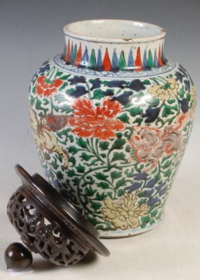 Lot 510 - A Chinese porcelain Wucai jar and wood cover,...