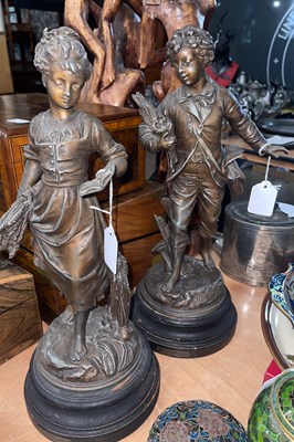 Lot 553 - A pair of bronzed spelter figures after...