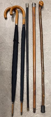 Lot 634 - Two silver topped walking canes; a wooden cane;...