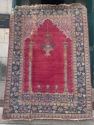 Lot 877 - A Persian prayer rug, the mihrab shaped madder...