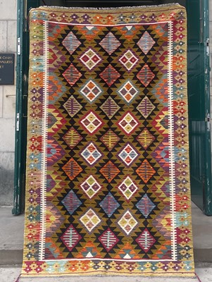 Lot 873 - An ochre ground Maimana kilim rug, the...