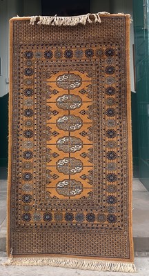 Lot 874 - A small ochre ground Persian runner, the...