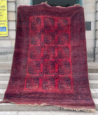 Lot 880 - An Afghan rug, 20th century, the madder ground...