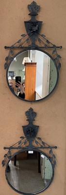 Lot 713A - A pair of circular wall mirrors with urn...