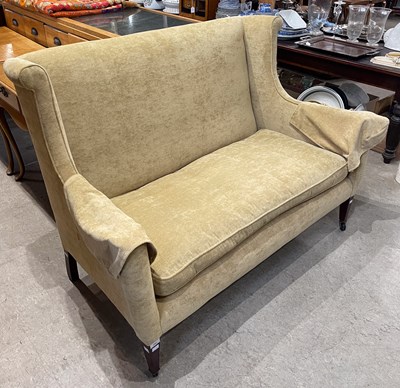 Lot 744 - An upholstered mahogany two seat wingback sofa,...