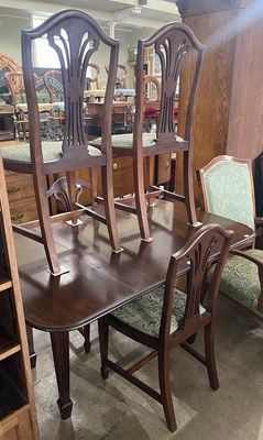 Lot 780 - A dining room suite comprising a mahogany drop-...