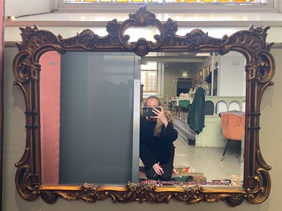 Lot 867 - A gilt framed rectangular bevelled wall mirror,...