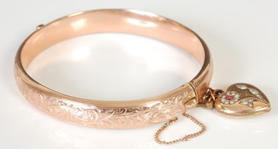 Lot 299 - A 9ct gold hinged bangle with yellow metal...