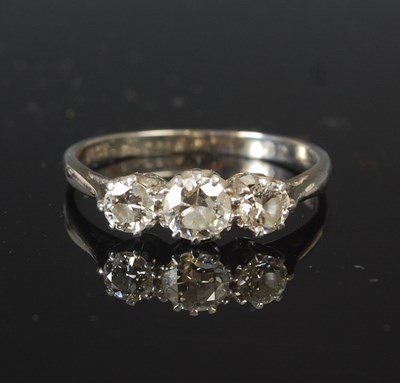 Lot 295C - A white metal and three stone diamond ring,...