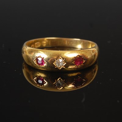 Lot 295A - An 18ct gold, ruby and diamond chip three...