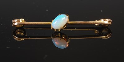Lot 295 - A yellow metal and opal set bar brooch,...