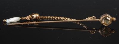 Lot 294 - A yellow metal and citrine topped stick pin,...