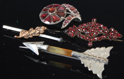 Lot 296A - A group of four brooches to include an arrow...