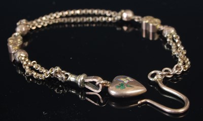 Lot 319G - A yellow metal chain suspending heart shaped...