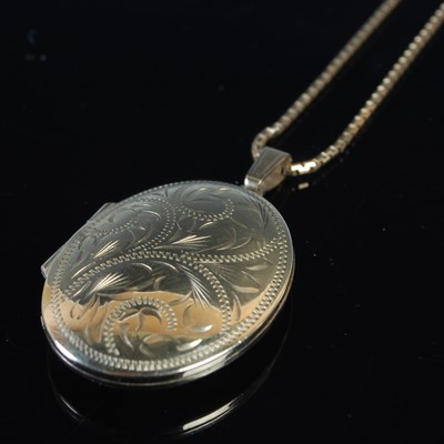 Lot 36 - A 9ct gold oval locket, suspended on 9ct gold...