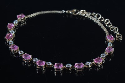 Lot 48 - A yellow and white metal pink sapphire set...