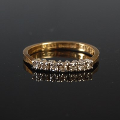 Lot 56 - An 18ct gold and diamond seven stone ring,...