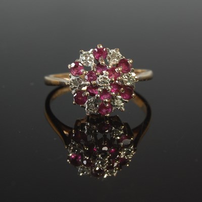 Lot 57 - A 9ct gold, garnet and diamond chip cluster...