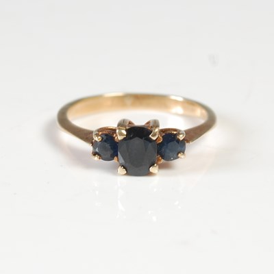 Lot 58 - A yellow metal and sapphire three stone dress...