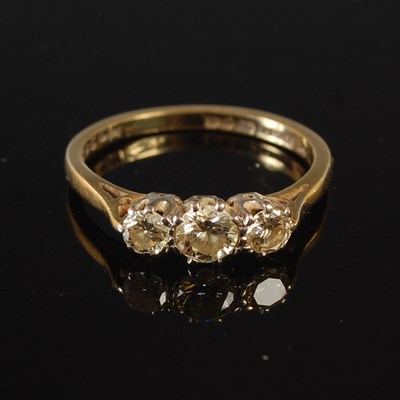 Lot 61 - An 18ct gold three stone diamond ring, size...