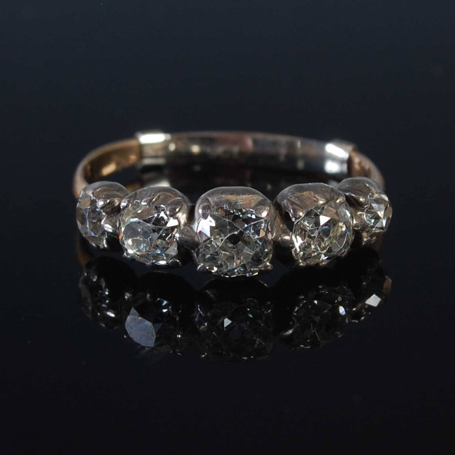 Lot 68 - A white and yellow metal five stone diamond...