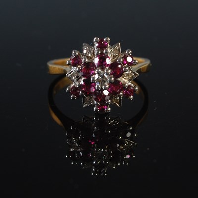 Lot 69 - A yellow metal, ruby and diamond cluster ring,...