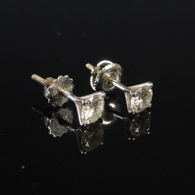 Lot 81 - A pair of white metal mounted diamond ear...