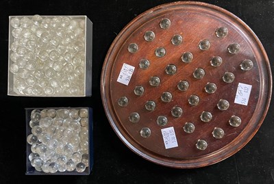 Lot 111 - A mahogany Solitaire board and clear glass...