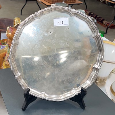 Lot 113 - A Sheffield silver salver on four scroll feet,...