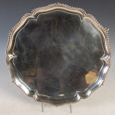 Lot 114 - A London silver salver raised on four claw and...