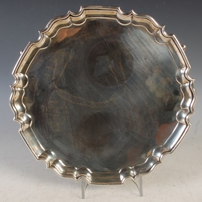 Lot 115 - A London silver salver raised on three shaped...