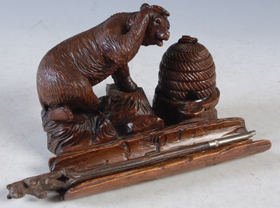 Lot 210 - A Black Forest carved wood desk stand, carved...