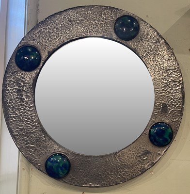 Lot 528 - An Arts & Crafts pewter circular bevelled wall...