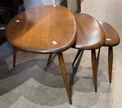 Lot 543 - A nest of three Ercol pebble shaped occasional...