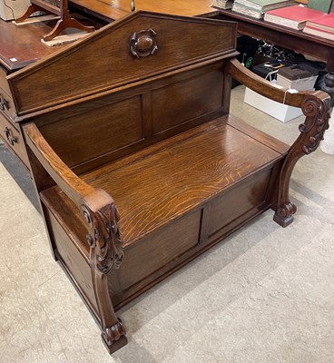 Lot 552 - An early 20th century oak hall settle, the...