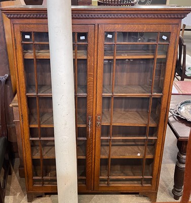 Lot 564 - An early 20th century oak bookcase, fitted...