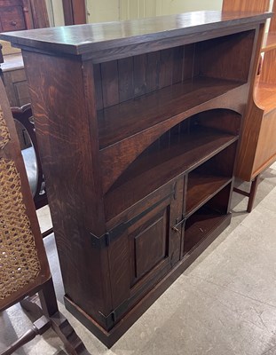 Lot 569 - An Arts & Crafts oak open bookcase, fitted...