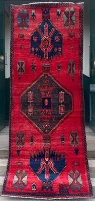 Lot 631 - A Persian Hamadan runner, the abrashed madder...