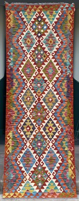 Lot 633 - A Chobi Kilim runner, the ivory ground worked...