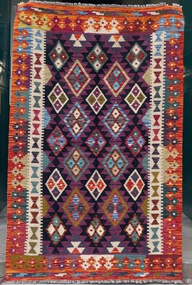 Lot 634 - A Maimana Kilim rug, the purple ground worked...