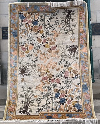 Lot 639 - A Chinese silk carpet, the ivory coloured...