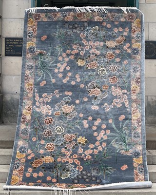 Lot 640 - A Chinese silk carpet, the blue/ grey ground...