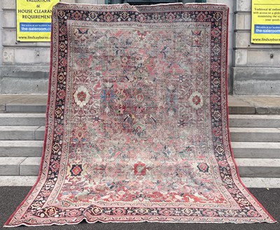 Lot 641 - A Persian carpet, the rectangular madder...